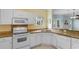 Bright kitchen featuring granite countertops, white appliances, and tiled floors at 1529 Lanterns Rest Dr. # 201, Myrtle Beach, SC 29579