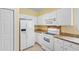 Well-lit kitchen featuring white appliances, cabinets and tile flooring at 1529 Lanterns Rest Dr. # 201, Myrtle Beach, SC 29579