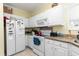 Kitchen featuring white cabinets, granite countertops, and white appliances at 1529 Lanterns Rest Dr. # 201, Myrtle Beach, SC 29579