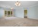 Inviting living room with blue walls, light fixtures, balcony access, and open access to the kitchen at 1529 Lanterns Rest Dr. # 201, Myrtle Beach, SC 29579