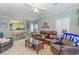 Open concept living room with a ceiling fan, dining area, and a view into the kitchen at 1529 Lanterns Rest Dr. # 201, Myrtle Beach, SC 29579