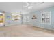 Bright living room with a fan, light blue walls, and neutral carpeting at 1529 Lanterns Rest Dr. # 201, Myrtle Beach, SC 29579