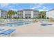 Community pool area with ample seating and views of the surrounding condo buildings at 1529 Lanterns Rest Dr. # 201, Myrtle Beach, SC 29579