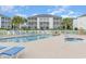 Community pool with ample seating, landscaping and multiple lounging chairs at 1529 Lanterns Rest Dr. # 201, Myrtle Beach, SC 29579