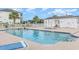 Community pool and jacuzzi with lounge chairs and lush landscaping at 1529 Lanterns Rest Dr. # 201, Myrtle Beach, SC 29579