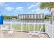 Beautiful waterfront view with white deck chairs overlooking the waterway and condo buildings at 1529 Lanterns Rest Dr. # 201, Myrtle Beach, SC 29579