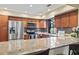 Modern kitchen featuring stainless steel appliances, granite countertops and wood cabinets at 1586 Bridgebrook Ln., Conway, SC 29527