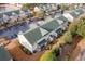 Aerial view of townhomes featuring green roofs, manicured landscaping, and private screened-in patios at 159 Chenoa Dr. # E, Murrells Inlet, SC 29576