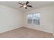 Well-lit carpeted bedroom with ceiling fan and window providing natural light at 159 Chenoa Dr. # E, Murrells Inlet, SC 29576