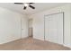 Bedroom with carpet, ceiling fan, closet, and a view into another room at 159 Chenoa Dr. # E, Murrells Inlet, SC 29576