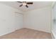 Carpeted bedroom featuring a ceiling fan and bi-fold closet doors for storage at 159 Chenoa Dr. # E, Murrells Inlet, SC 29576