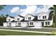 Modern townhomes with a white exterior, black roof, and individual garages at 159 Hoffman Park Dr. # 79, Myrtle Beach, SC 29588