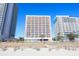 Beachfront hotel exterior with balconies and palm trees at 1604 N Ocean Blvd. # 605, Myrtle Beach, SC 29577