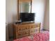 Bedroom featuring dresser with TV and decorative mirror at 1605 S Ocean Blvd. # 612, Myrtle Beach, SC 29577