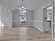 Dining room with chandelier, natural light, chair rail, and open access to kitchen at 1639 Coventry Rd., Surfside Beach, SC 29575