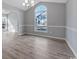 Dining room area with a large window and wood-look vinyl flooring at 1639 Coventry Rd., Surfside Beach, SC 29575