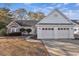 Charming one-story home featuring a brick facade, two-car garage and well-maintained landscaping at 1639 Coventry Rd., Surfside Beach, SC 29575