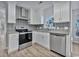 Modern kitchen featuring stainless steel appliances, granite countertops, and white cabinets at 1639 Coventry Rd., Surfside Beach, SC 29575