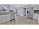 Bright kitchen with stainless steel appliances, granite counters, and wood-look vinyl flooring at 1639 Coventry Rd., Surfside Beach, SC 29575