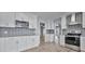 Bright kitchen with updated stainless steel appliances, white cabinets, and patterned backsplash at 1639 Coventry Rd., Surfside Beach, SC 29575
