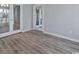 Living room with wood-look vinyl floors and glass paneled doors at 1639 Coventry Rd., Surfside Beach, SC 29575