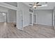 Bright living room with vaulted ceilings, ceiling fan, glass doors, and neutral paint at 1639 Coventry Rd., Surfside Beach, SC 29575