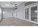 Bright living room featuring vaulted ceilings, ceiling fan, glass doors and neutral paint at 1639 Coventry Rd., Surfside Beach, SC 29575