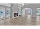 Open-concept living area with a fireplace and glass doors for natural light, blending comfort with style at 1639 Coventry Rd., Surfside Beach, SC 29575
