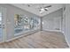 Bright living room featuring vaulted ceilings, a ceiling fan, large windows, and neutral paint at 1639 Coventry Rd., Surfside Beach, SC 29575