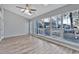 Bright sun room with large windows, ceiling fan, and door to exterior at 1639 Coventry Rd., Surfside Beach, SC 29575