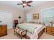 Comfortable bedroom with a ceiling fan, plush carpet, and natural light coming from the window at 1796 Fairwinds Dr., Longs, SC 29568