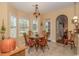 Bright breakfast nook features a charming dining set and many windows overlooking the backyard at 1796 Fairwinds Dr., Longs, SC 29568