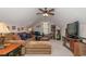 Cozy living room with comfortable seating, ceiling fan, and natural light coming from the window at 1796 Fairwinds Dr., Longs, SC 29568