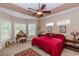 Serene main bedroom with a tray ceiling, neutral decor, and a vanity offers a peaceful retreat at 1796 Fairwinds Dr., Longs, SC 29568