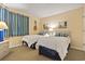 Bedroom featuring two twin beds, colorful curtains, and neutral wall color at 180 Rothbury Circle # 303, Myrtle Beach, SC 29572