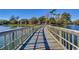 Wooden boardwalk stretches across a picturesque lake under a bright, sunny sky at 180 Rothbury Circle # 303, Myrtle Beach, SC 29572