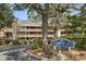 Condo building featuring layered decks and lush landscaping with community signage reading Arrowhead Court at 180 Rothbury Circle # 303, Myrtle Beach, SC 29572