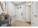 Inviting foyer with neutral tile, decorative console, and coat closet at 180 Rothbury Circle # 303, Myrtle Beach, SC 29572