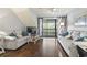 Bright living room featuring hardwood floors and sliding glass door to balcony at 180 Rothbury Circle # 303, Myrtle Beach, SC 29572