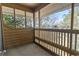 Covered porch with wooden railing overlooking scenic trees and pond at 180 Rothbury Circle # 303, Myrtle Beach, SC 29572