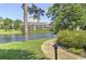 Picturesque view of the lake, surrounded by manicured green spaces and residential buildings at 180 Rothbury Circle # 303, Myrtle Beach, SC 29572