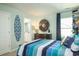 Light filled bedroom with a surfing theme, wooden sunburst mirror, and a connecting bathroom view at 1808 Sunshine Ct., North Myrtle Beach, SC 29582