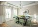 Elegant dining room with a large table, decorative chandelier, and natural light at 1808 Sunshine Ct., North Myrtle Beach, SC 29582