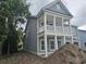 Stylish two-story home featuring a welcoming porch with white columns at 1808 Sunshine Ct., North Myrtle Beach, SC 29582