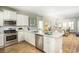 Modern kitchen with white cabinets, granite countertops, stainless steel appliances, and kitchen island at 1808 Sunshine Ct., North Myrtle Beach, SC 29582