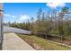 Exterior shot of the backyard, featuring a concrete patio, sloped lawn, and a privacy fence at 188 Timber Oaks Dr., Myrtle Beach, SC 29588