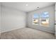 Bright bedroom with carpet and large windows overlooking neighborhood at 188 Timber Oaks Dr., Myrtle Beach, SC 29588