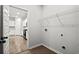 Bright laundry room with storage rack and wood-look tile flooring, ready for appliances at 188 Timber Oaks Dr., Myrtle Beach, SC 29588