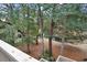 View of wooded backyard, trees, and natural creek area seen from deck stairs at 222 Westleton Dr. # 18D, Myrtle Beach, SC 29572