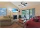 Bright living room featuring a fireplace, ceiling fan, and sliding glass doors to the balcony at 222 Westleton Dr. # 18D, Myrtle Beach, SC 29572